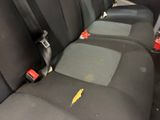 a close up of a seat in a car with a yellow sticker on it