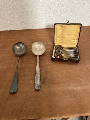 two spoons and two spoons sitting on a table