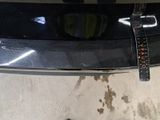 a car that has a tag attached to it ' s bumper