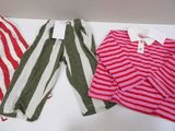 two pairs of striped pants and a striped shirt on a white table