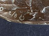 a close up of a piece of metal on a blue cloth
