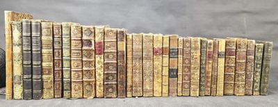 several old books stacked on top of each other on a table