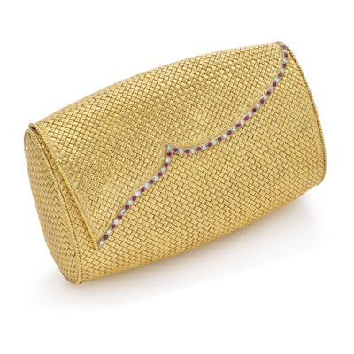 the gold clutch bag is made from woven fabric and has a beaded handle