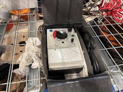 a box that has a meter in it on a shelf