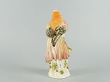 an image of a figurine of a woman holding a flower