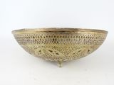 an antique brass bowl on a stand with a white background