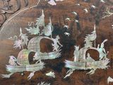 two boats that are painted on the side of a table