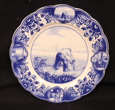an old blue and white plate with a picture of an elephant on it