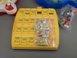 a yellow game board with lots of items on the table