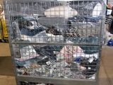 a metal cart with many items in it in a warehouse