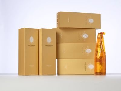 three boxes of champagne and a bottle of champagne sitting on a table