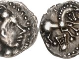 a close up of a silver coin with a design on it