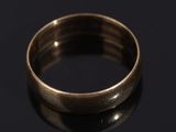 a close up of a gold ring on a black surface