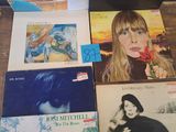 a lot of records on a wooden table