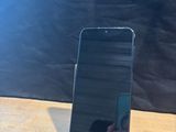 a cell phone that is sitting on top of a wooden table