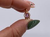 a person holding a ring with a green stone on it