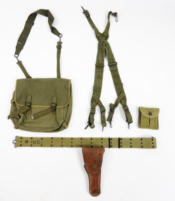 a bag, belt, holster and other items laid out on a white surface
