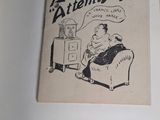 an old book with a cartoon of a man sitting on a couch