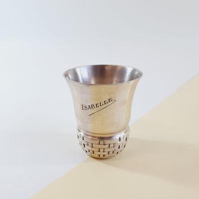 a silver cup sitting on top of a table