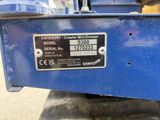 a close up of a blue machine with a sign on it