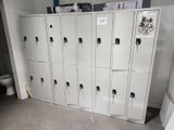 a bunch of lockers in a room with a toilet in the background