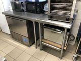 stainless steel counter top with oven, microwave, and toaster on it