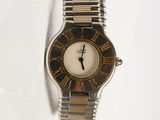 a silver and gold wrist watch on a white surface