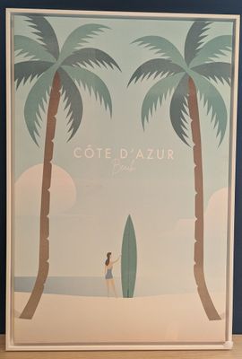 a picture of a woman holding a surfboard in front of two palm trees