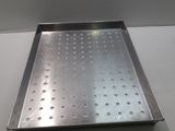 a metal tray with holes on it on a table