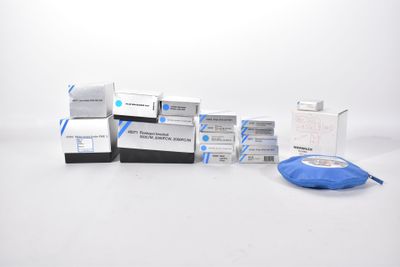 several boxes of blue and white medical supplies sitting on a white surface