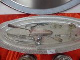 a silver platter with silver spoons and spoons on it