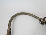 a metal hose attached to a wall mounted faucet