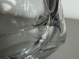 a clear glass vase with a black and white swirl on it