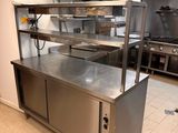 a large kitchen with stainless steel counter tops and stainless steel cabinets