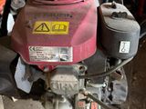 a red and yellow moped parked in a garage