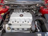 the engine of a red car with its hood open