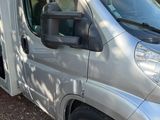 a silver van that is parked on the side of the road