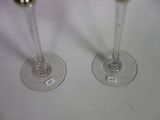 two wine glasses that are sitting on a table
