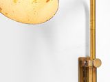 a close up of a lamp on a wall next to a white wall