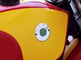 a red and yellow motorcycle parked on the side of the street