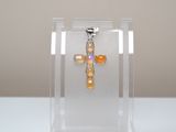 a small cross in a clear box on a table