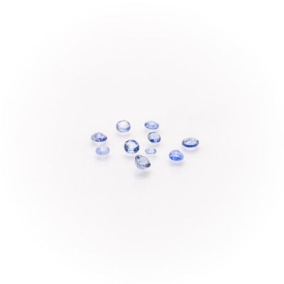 a group of blue sapphires on a white surface