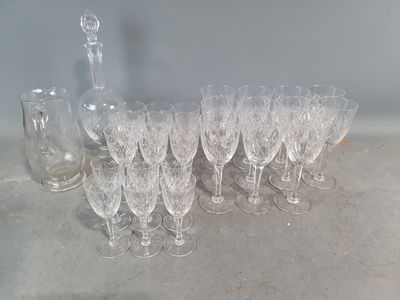 a lot of wine glasses and a decanter on the table