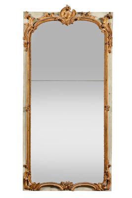 a large mirror with a gold frame and ornate design