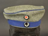 a grey hat with a blue band on top of it
