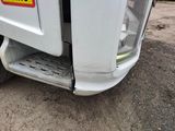 a close up of a white truck with a yellow sticker on it ' s side