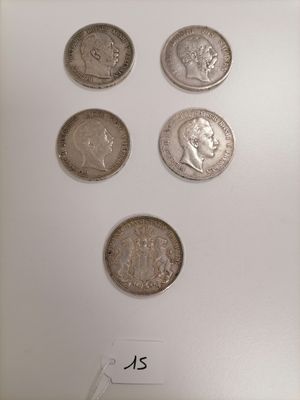 a close up of four different coins on a white surface