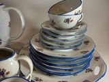 a lot of plates and cups on the table