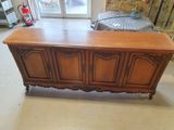 a large wooden chest in the middle of a room