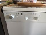 a white dishwasher sitting on top of a kitchen counter